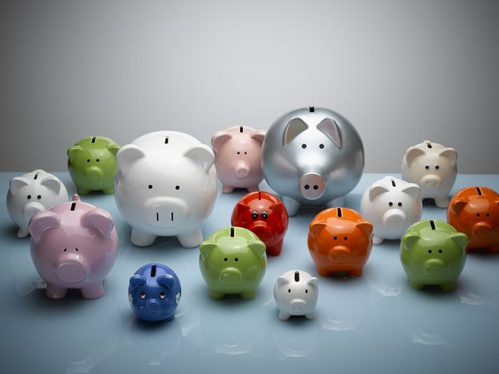 Multicolor piggy banks still life / Getty Images