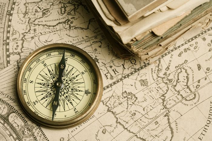 Old compass over ancient map / Getty Images