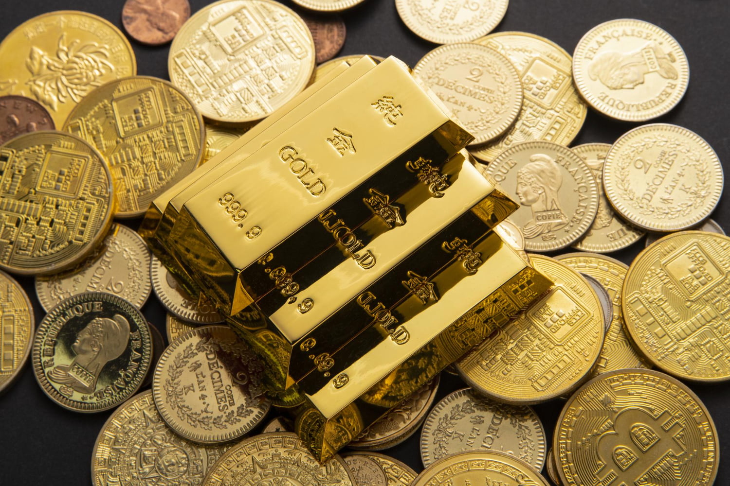 closeup shot of pile of shiny gold coins and bars